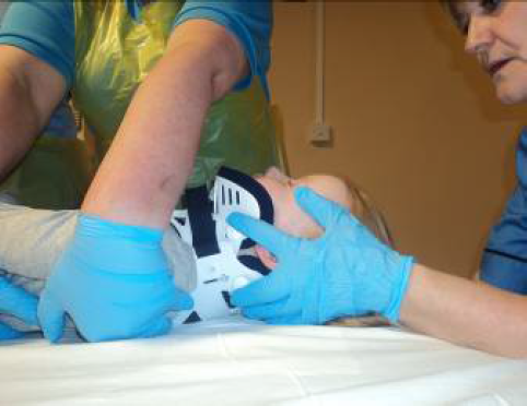 Team leader holding the child's head and collar